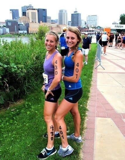two women standing next to each other with tattoos on their arms.