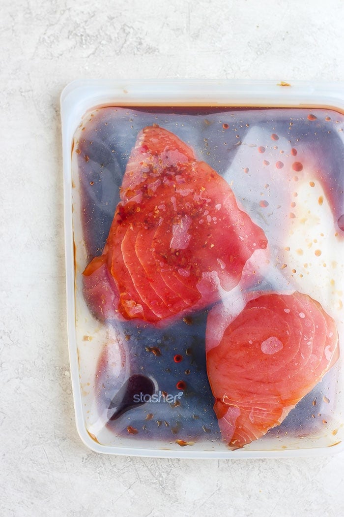 ahi tuna steak being marinaded.