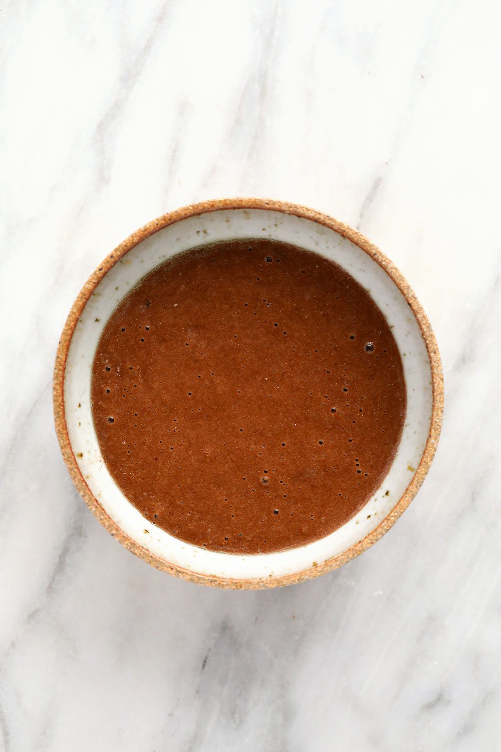 chocolate mug cake batter in a mug, ready to be baked or made in the microwave