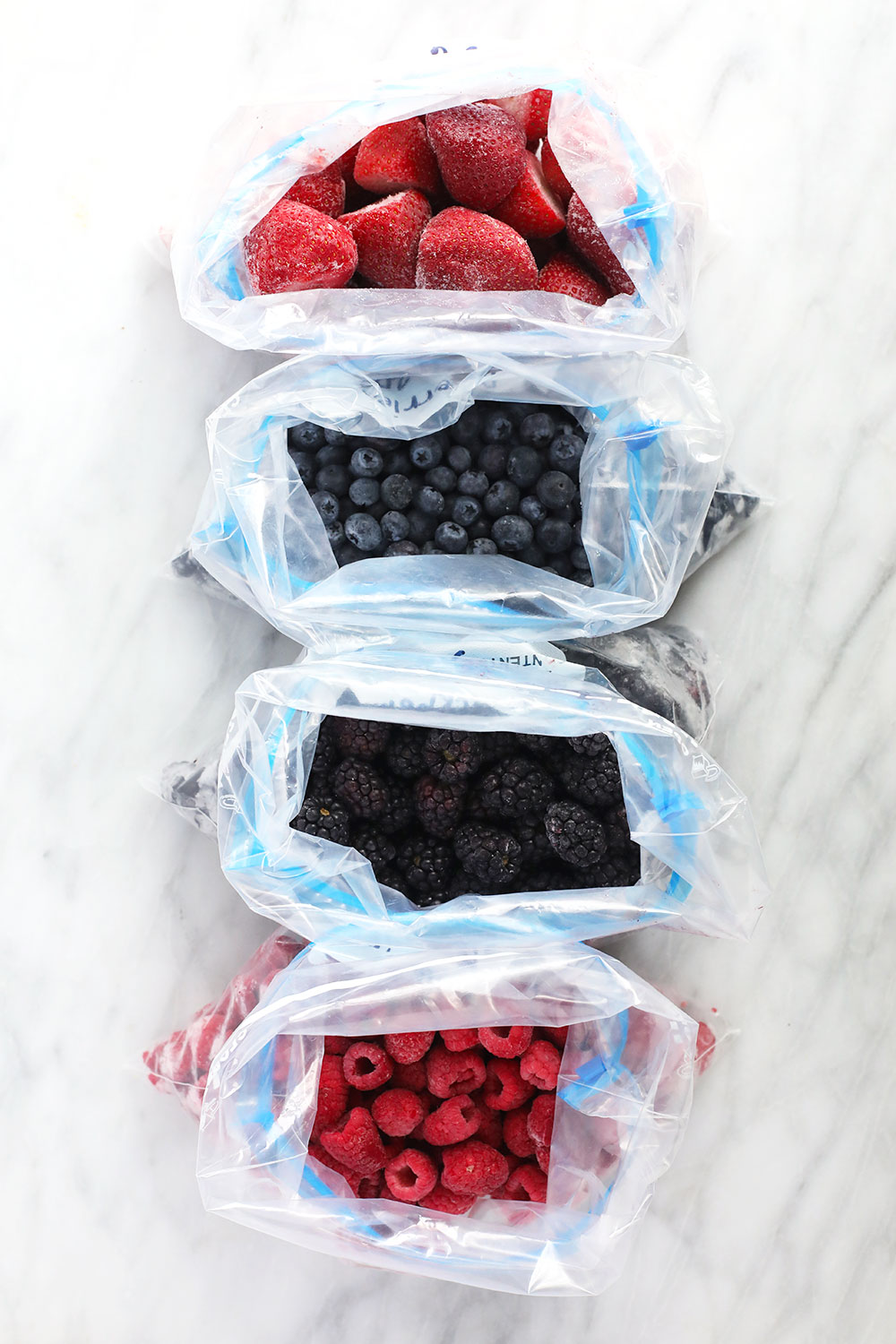 frozen berries in ziploc bags ready to be placed in the freezer
