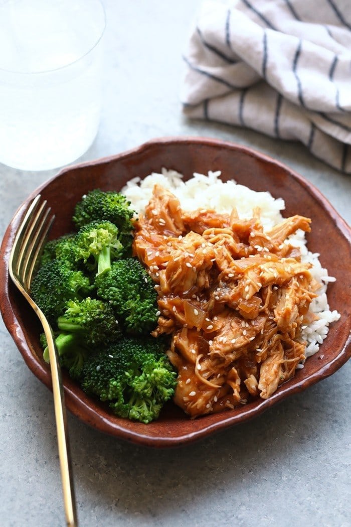 crockpot sesame chicken in a bowl with rice and broccoli