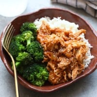 a Crockpot bowl of sesame chicken with broccoli.