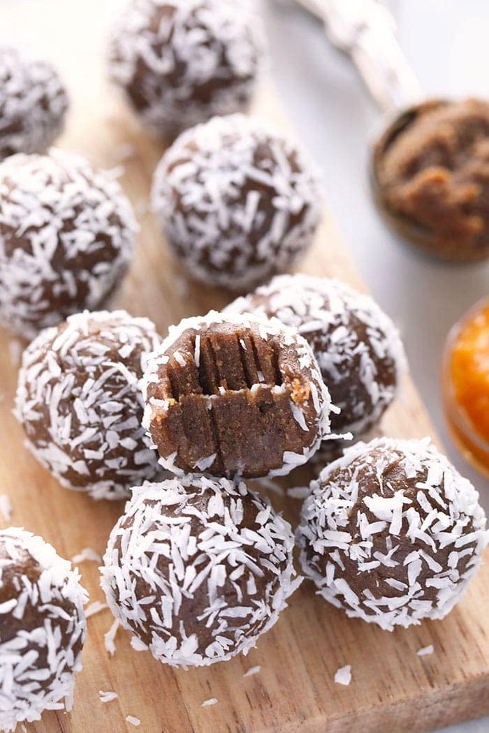 Energy balls stacked on a cutting board