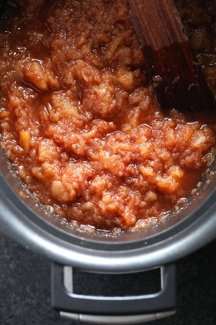 cinnamon crockpot applesauce in a crockpot ready to be eaten