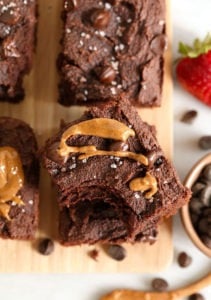 Paleo chocolate peanut butter brownies on a cutting board.