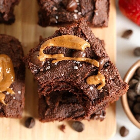 Paleo peanut butter chocolate brownies on a cutting board.