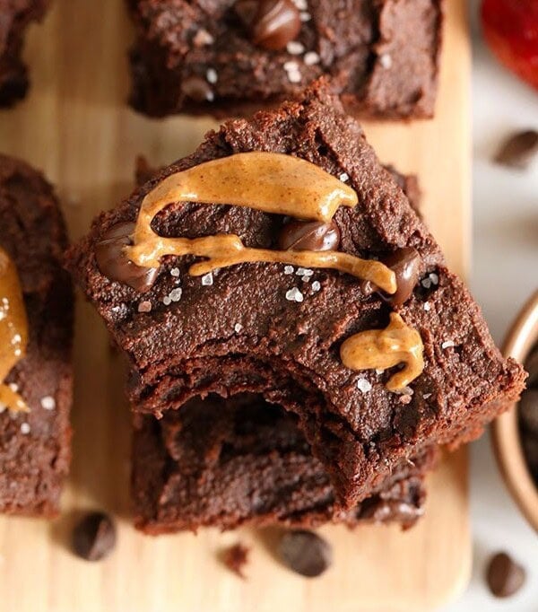 Paleo peanut butter chocolate brownies on a cutting board.