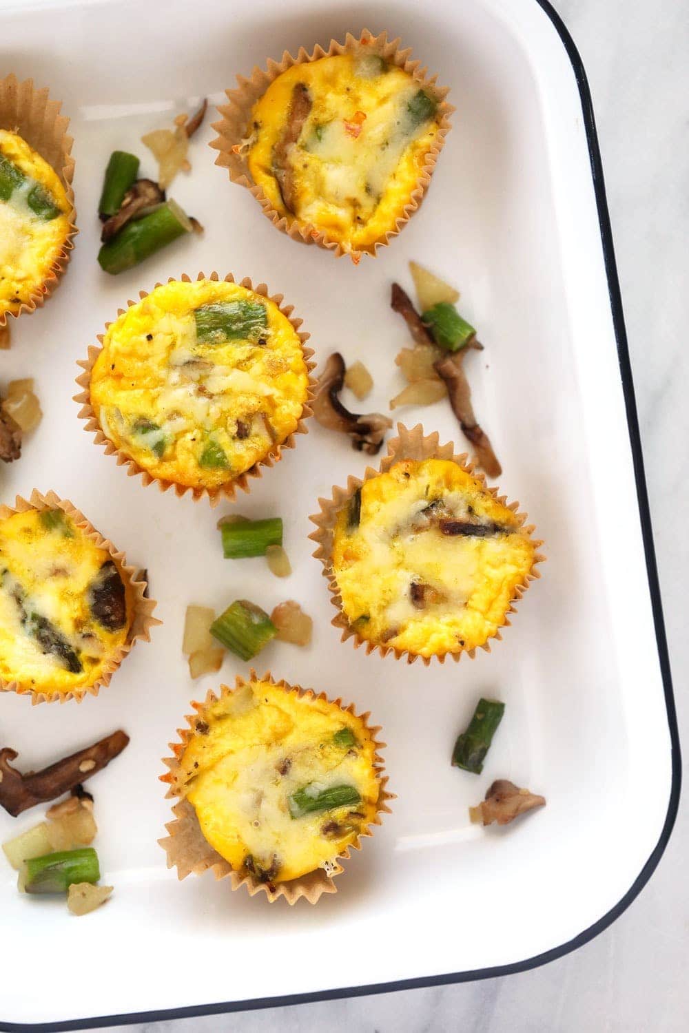 asparagus ad mushroom egg cups in a pan