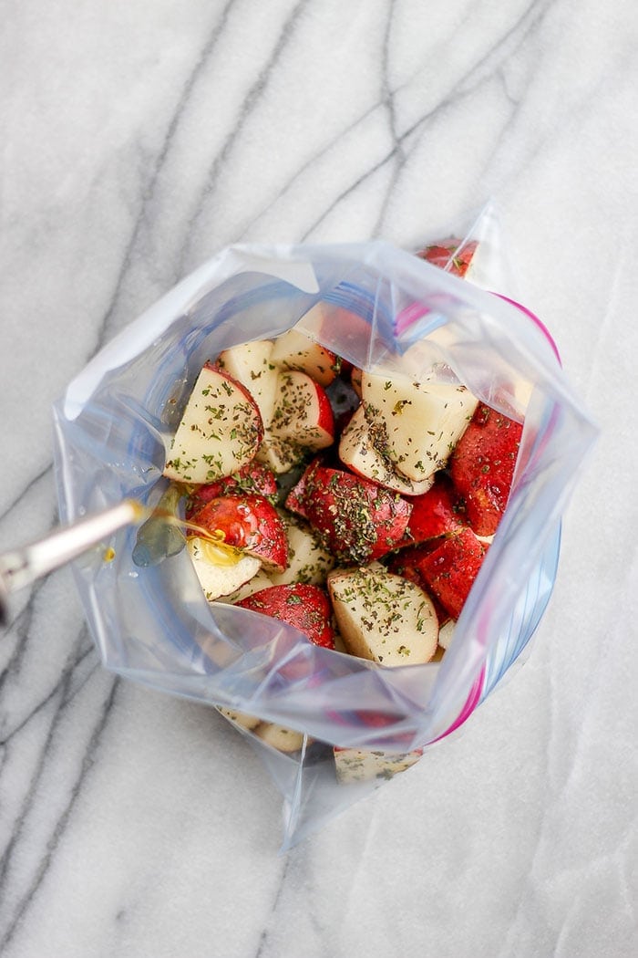 red potatoes and spices in a plastic bag