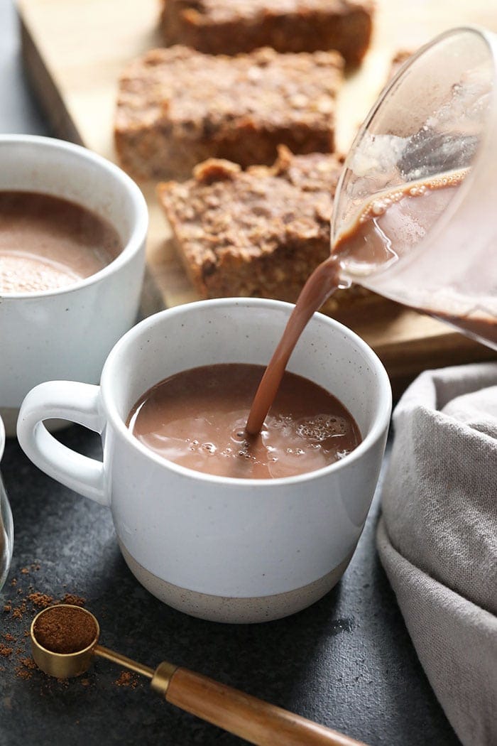 vegan chai hot chocolate being poured in a mug
