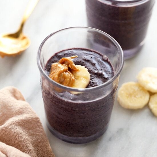 two glasses of blueberry chia pudding with bananas.
