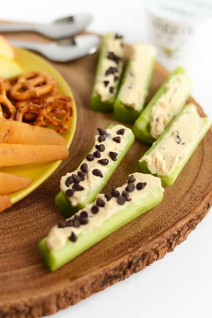 peanut butter greek yogurt dip spread in celery slices for ants on a log