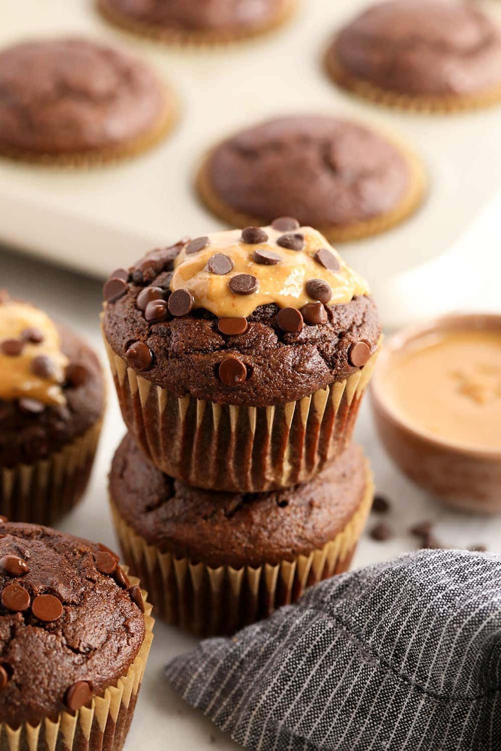 healthy chocolate peanut butter muffins stacked