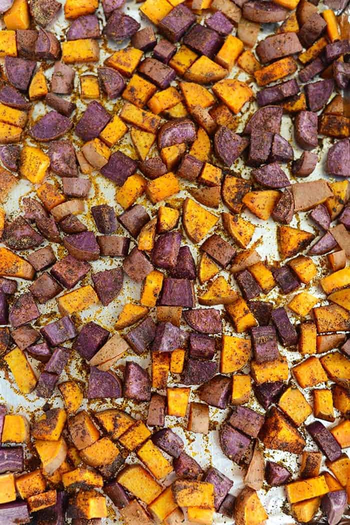 purple and orange sweet potatoes salted on cooking pan