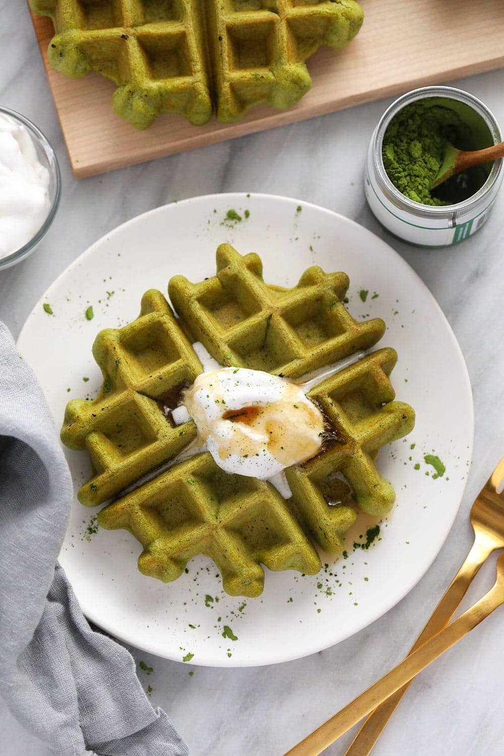 matcha waffle on plate with coconut whipped cream