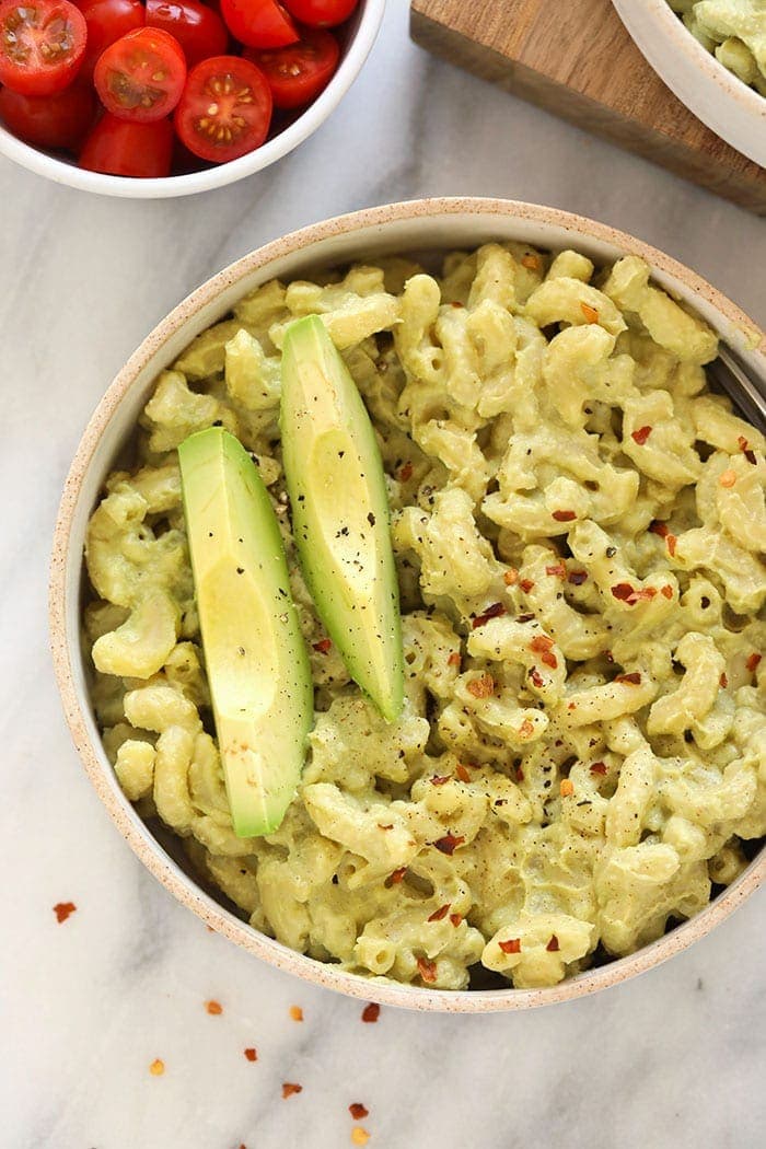 avocado mac and cheese with sliced avocado