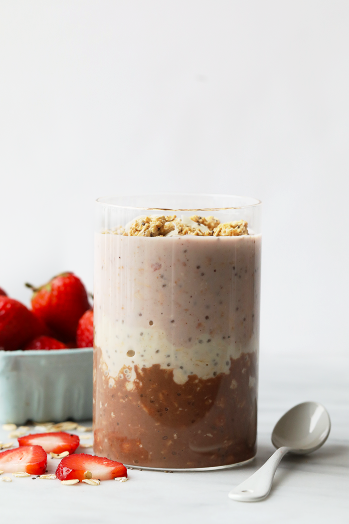 Neapolitan overnight oats served in a glass jar. 