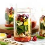 A Spring Cobb Salad served in a mason jar.