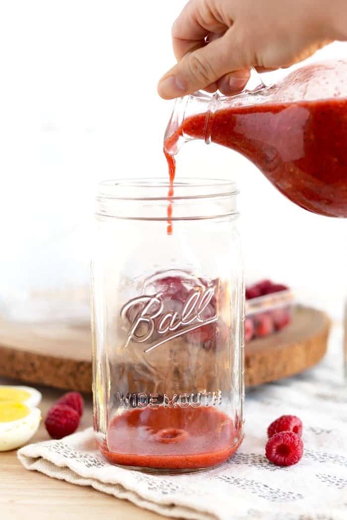 Pouring Raspberry Vinaigrette into a jar 