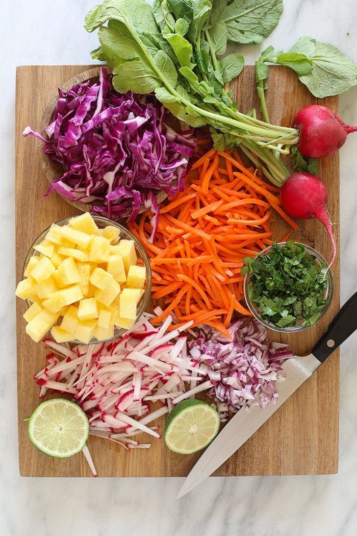 Coleslaw ingredients on a cutting board