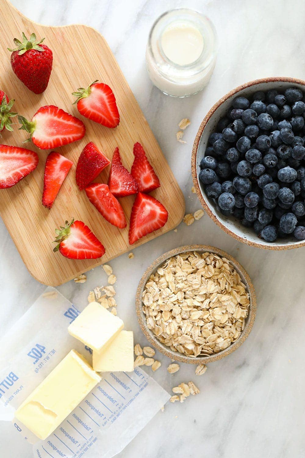 rolled oats, sliced strawberries, butter, milk, and blueberries