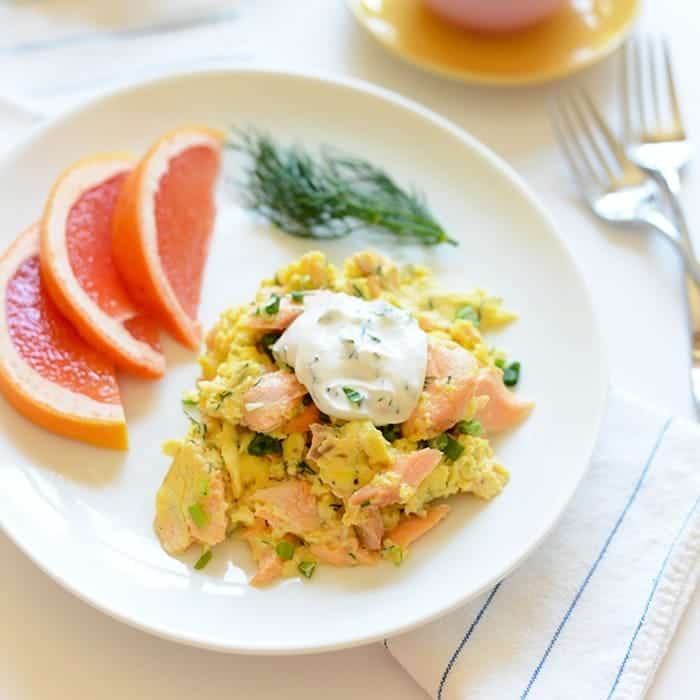 salmon and scrambled eggs with side of grapefruit slices