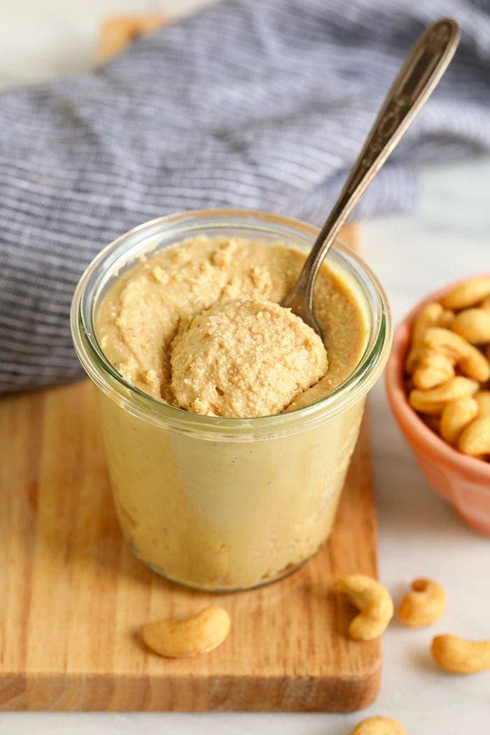 cashew butter in a glass jar with a spoon