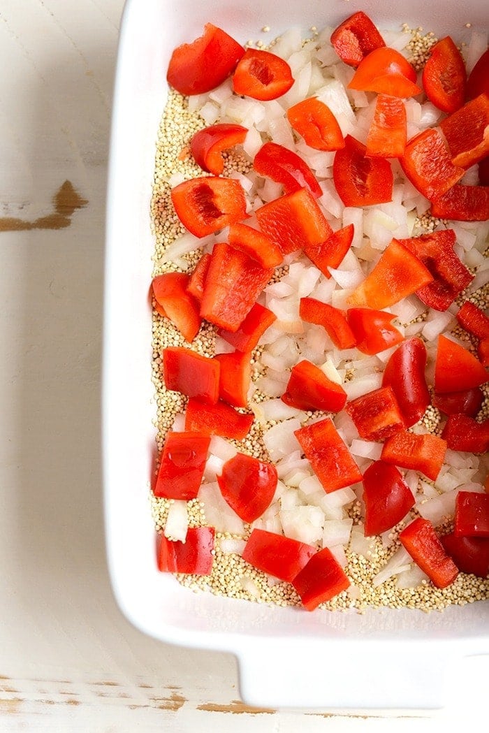 Make this Cashew Chicken Quinoa Bake for a high-protein, one-dish meal that the whole family will love! Meal prep at its finest. Quinoa, red peppers, and onion in a casserole dish