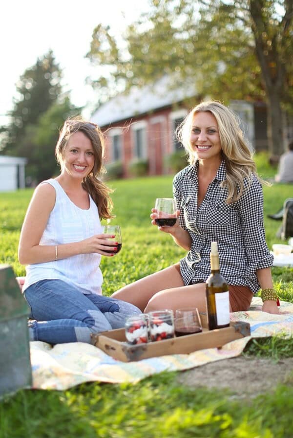 Two women at The Pizza Farm enjoying a picnic with wine.