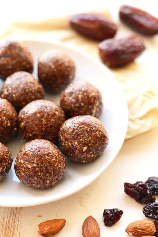 a plate of energy balls with raisins and nuts.