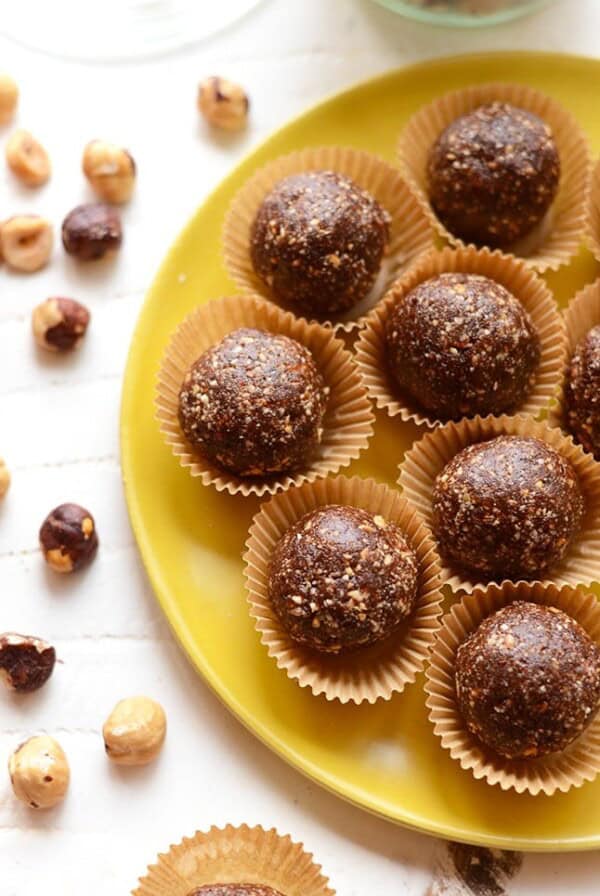 Energy balls made of chocolate and peanut butter, served on a yellow plate.