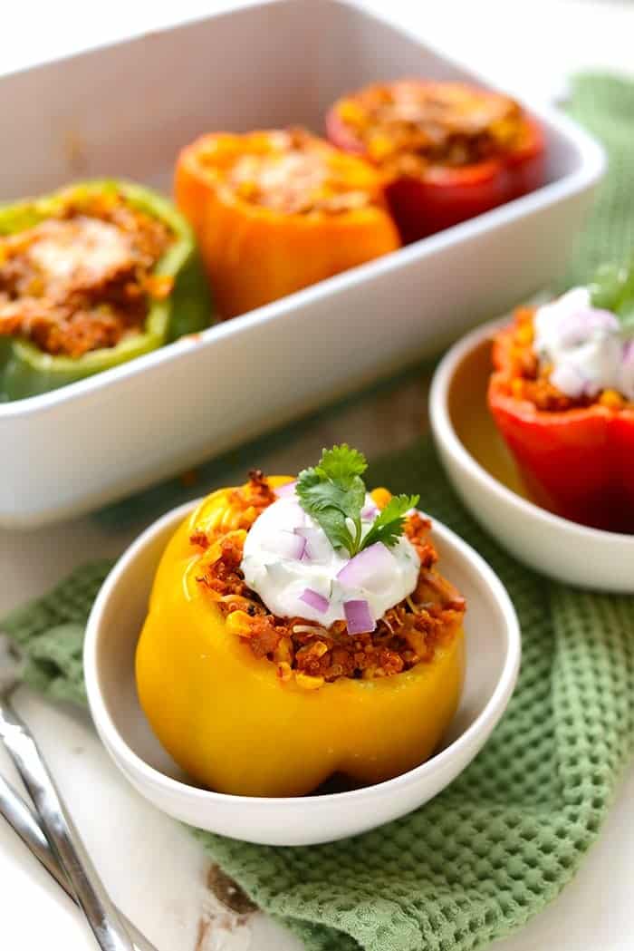 mexican stuffed peppers topped with greek yogurt and cilantro