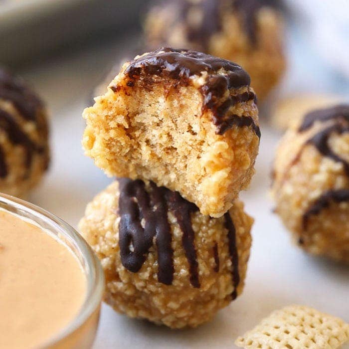 A bowl of granola bites with a scoop of peanut butter dipping sauce.