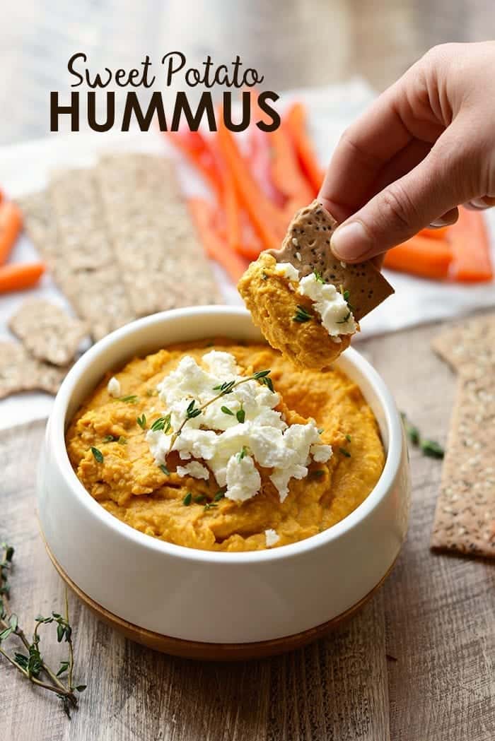 sweet potato hummus in cracker from white bowl