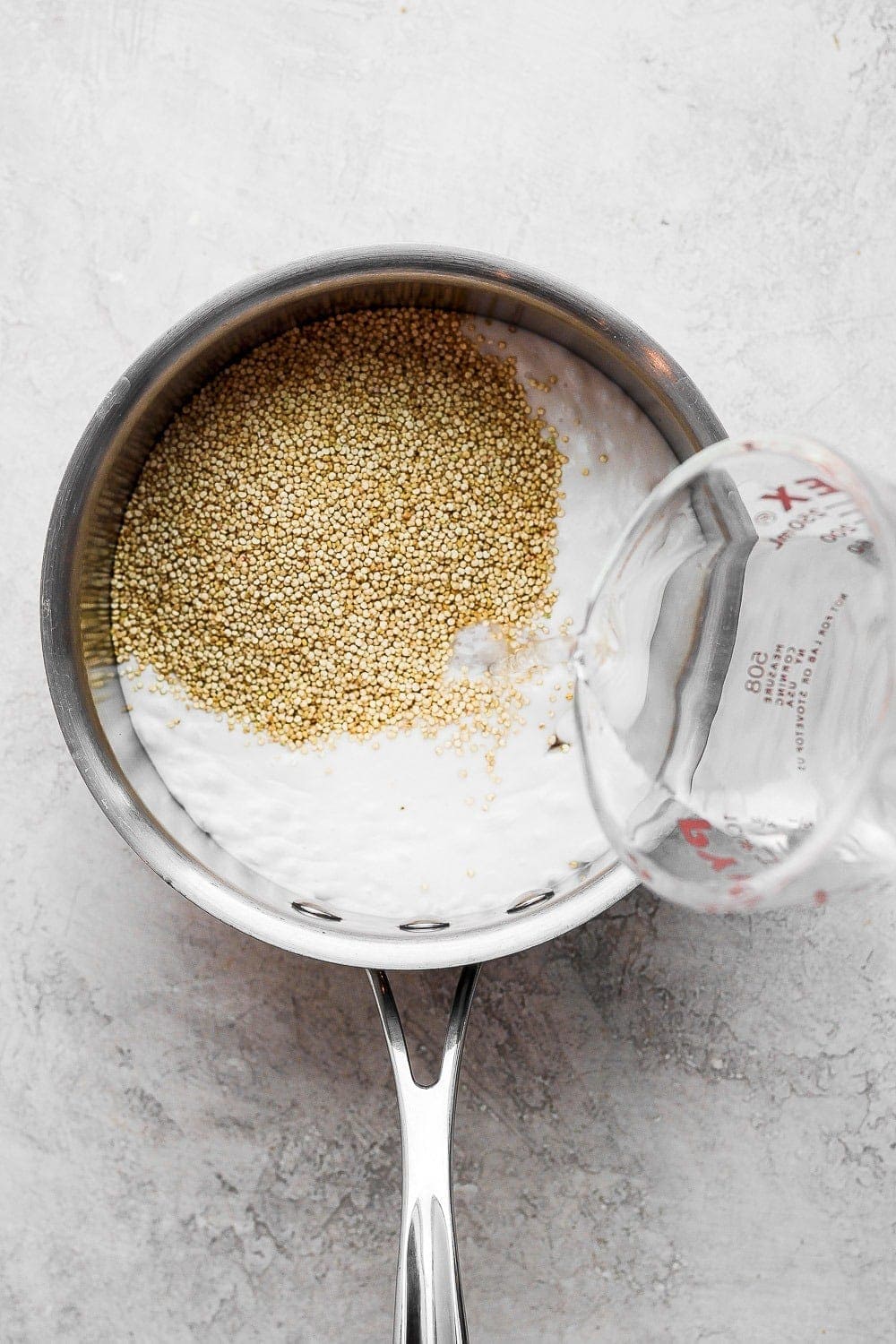 Quinoa and coconut milk in a sauce pan