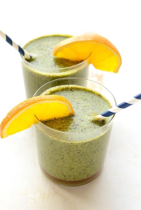two glasses of green smoothie with spinach.