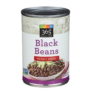 A can of black beans on a white background, perfect for shredded chicken tacos.