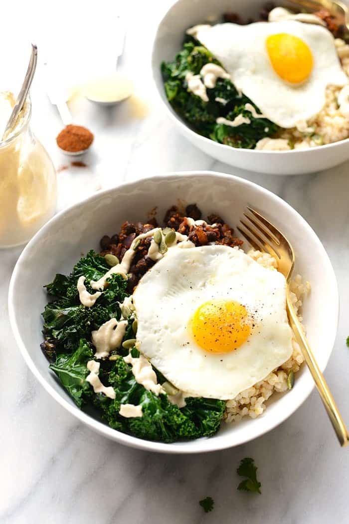 Make your breakfast a savory one and prep these delicious black bean breakfast bowls for the week! They're made with black beans, sautéed kale, brown rice, an egg, and all the fixins! 