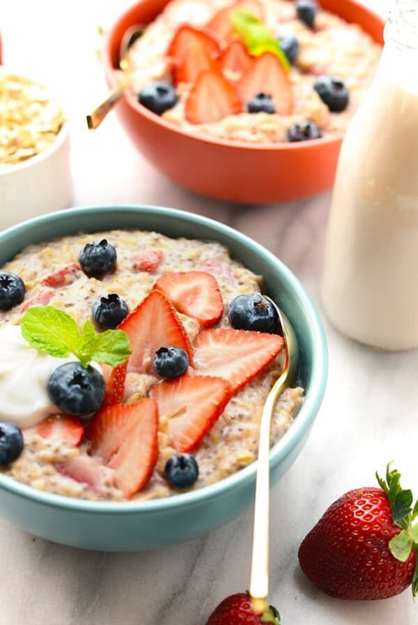 Two bowls of strawberries and cream oatmeal.