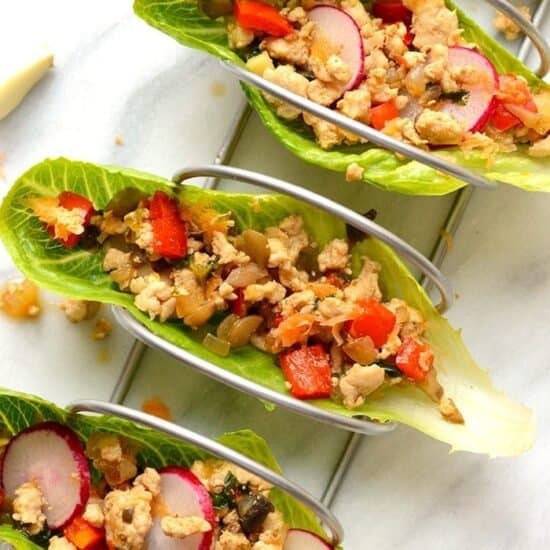thai chicken lettuce wraps in taco holder with radishes and peppers
