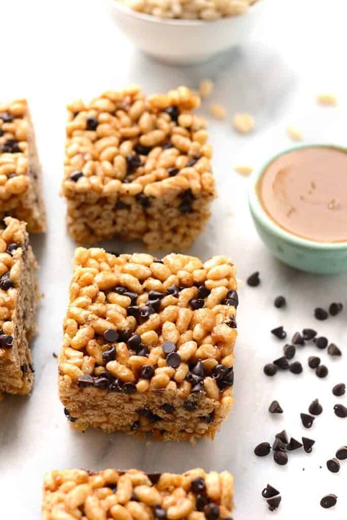 A plate of granola bars with peanut butter and chocolate chips, resembling brown rice crispy treats.