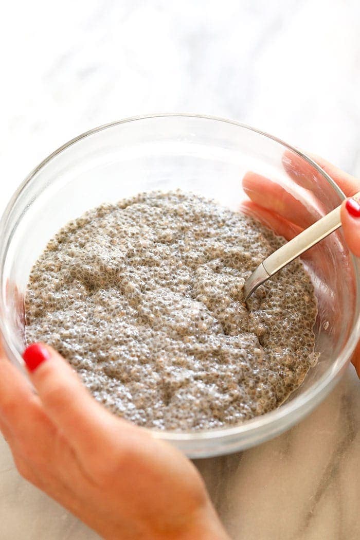 chia seed pudding being stirred in a bowl