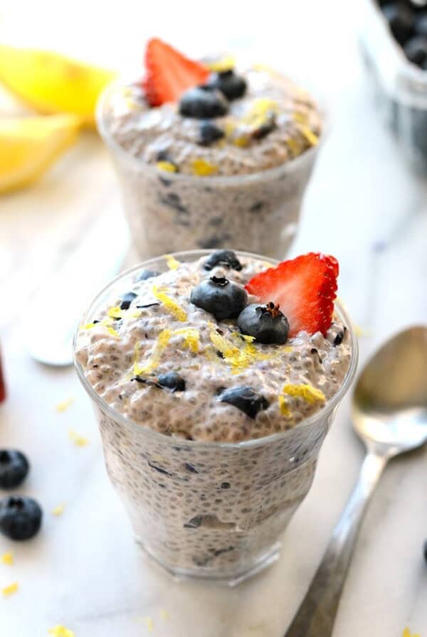 Two cups of blueberry chia seed pudding with spoons.