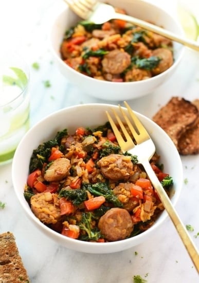 sausages and spinach mixed with sweet potato and kale hash over rice.