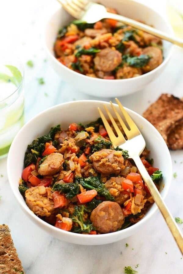 sausages and spinach mixed with sweet potato and kale hash over rice.