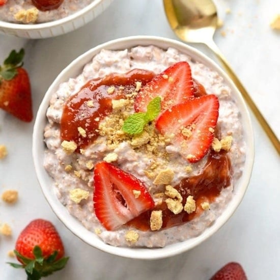 Overnight oats with strawberry cheesecake flavors topped with granola.