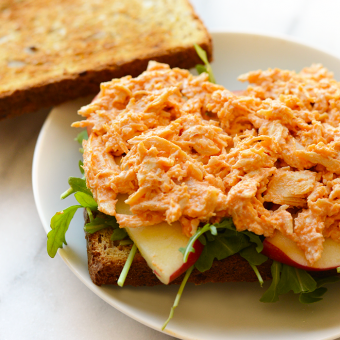 At just 150 calories, 1g carb, and 2g fat per serving, this Healthy Buffalo Chicken is packed with protein and super easy to make! You'll never need another buffalo chicken recipe again after trying this simple 3-ingredient recipe. It's naturally gluten-free and a great meal-prep lunch recipe.