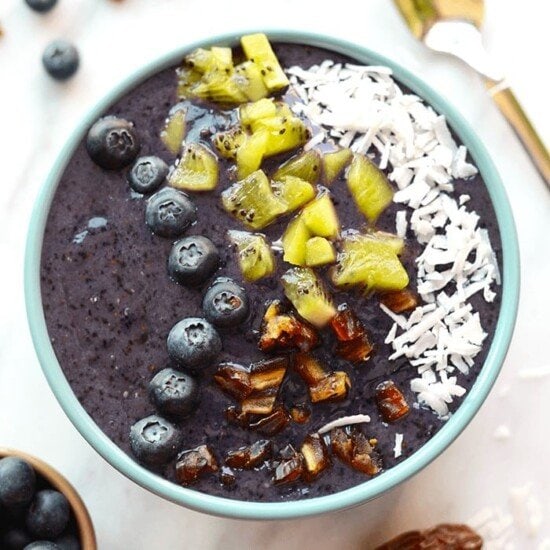 Blueberry date smoothie bowls filled with coconut and granola.