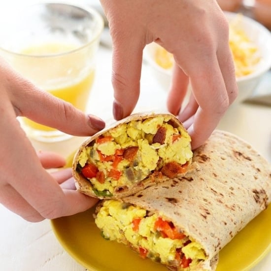 a person is preparing a nutritious burrito with eggs.