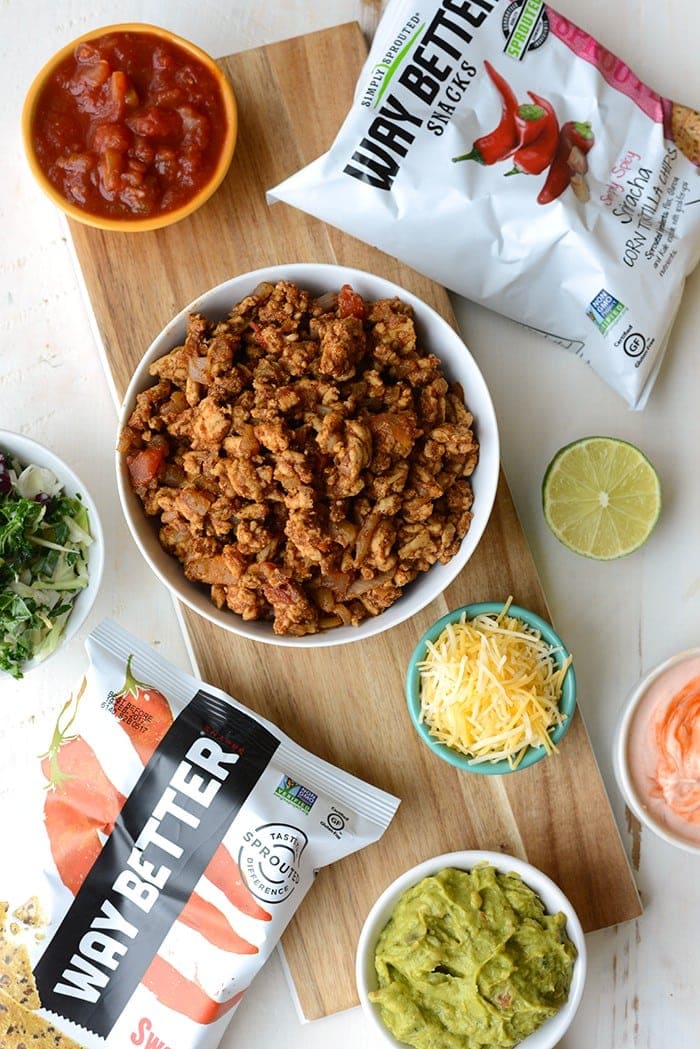 How to Make Healthy Walking Tacos - Up your walking taco game with my favorite Way Better Snacks, lean ground turkey taco meat, and a delicious kale slaw topped with all of your favorite fixings!
